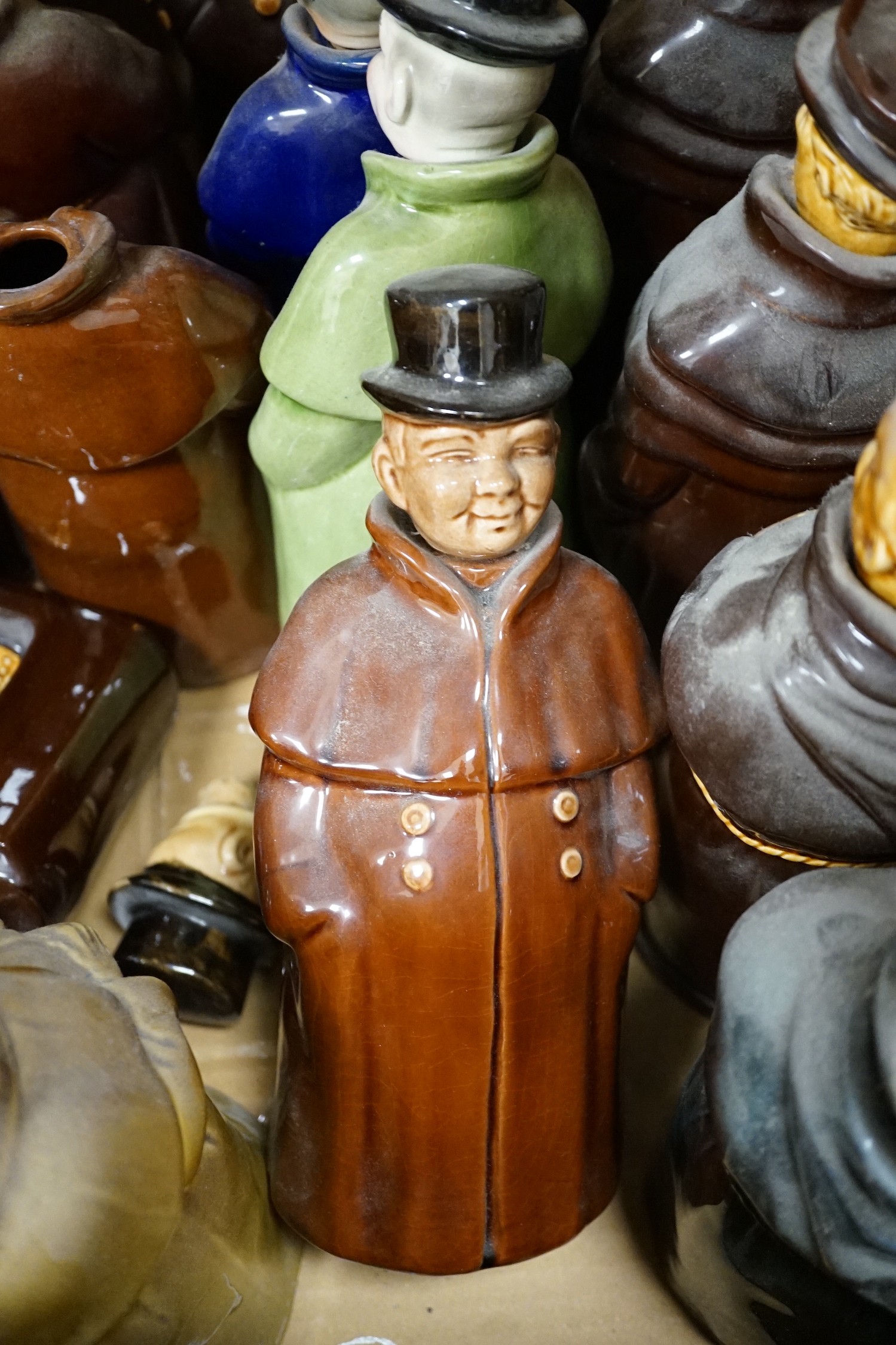 A group of twenty three Doulton ‘style’ figural spirit flasks and a jug
